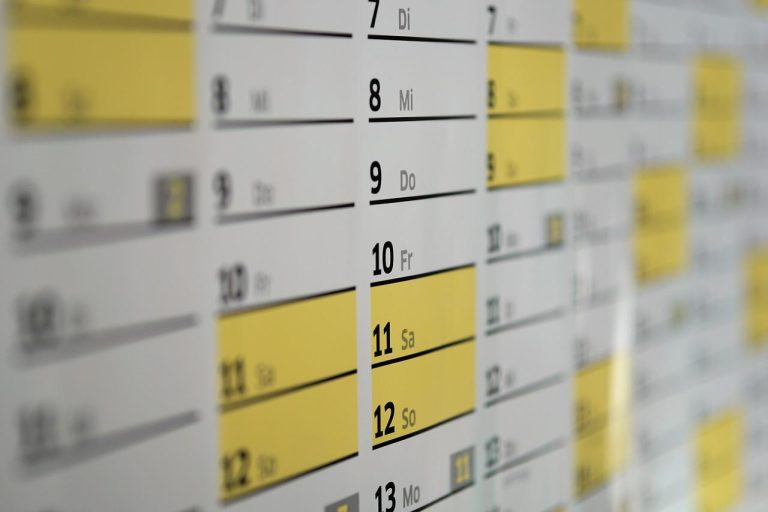 Close-up of a calendar with yellow highlights.